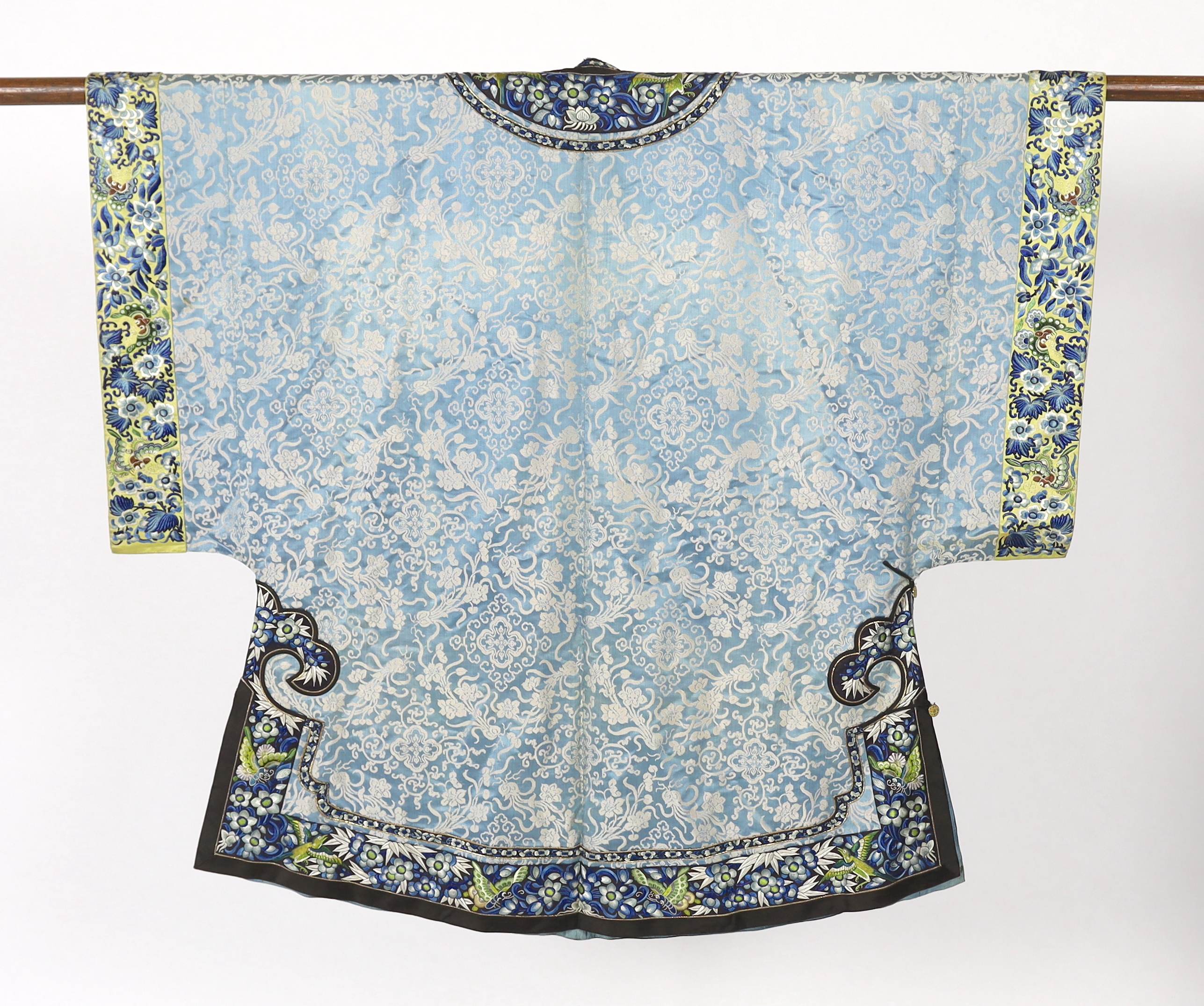 A late 19th / early 20th century silk damask robe, edged with highly ornate embroidered silk braiding, edged with fine gold and black borders, with yellow silk embroidered sleeve bands, the blue silk lining is faded in p